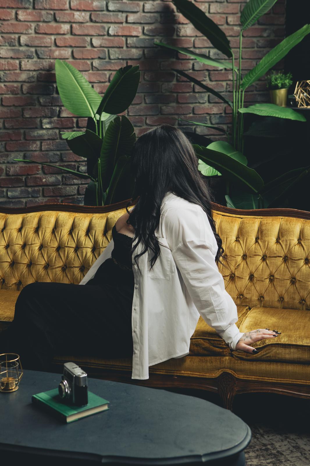 author sitting on vintage gold couch