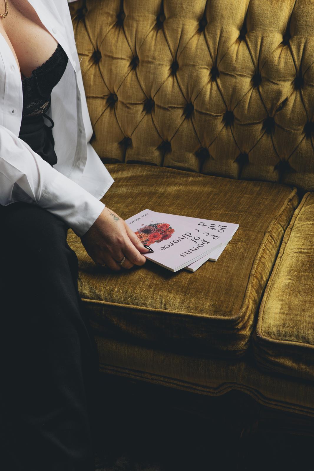 poems of divorce book displayed on couch