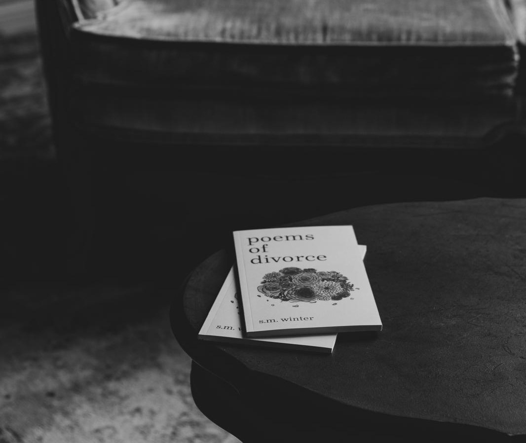 poems of divorce books displayed on table